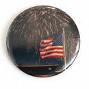 Button badge with American flag and fireworks design on a white background