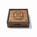 Wooden box with engraved design on a beige wall
