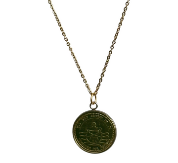Gold necklace with a round pendant on a white background
