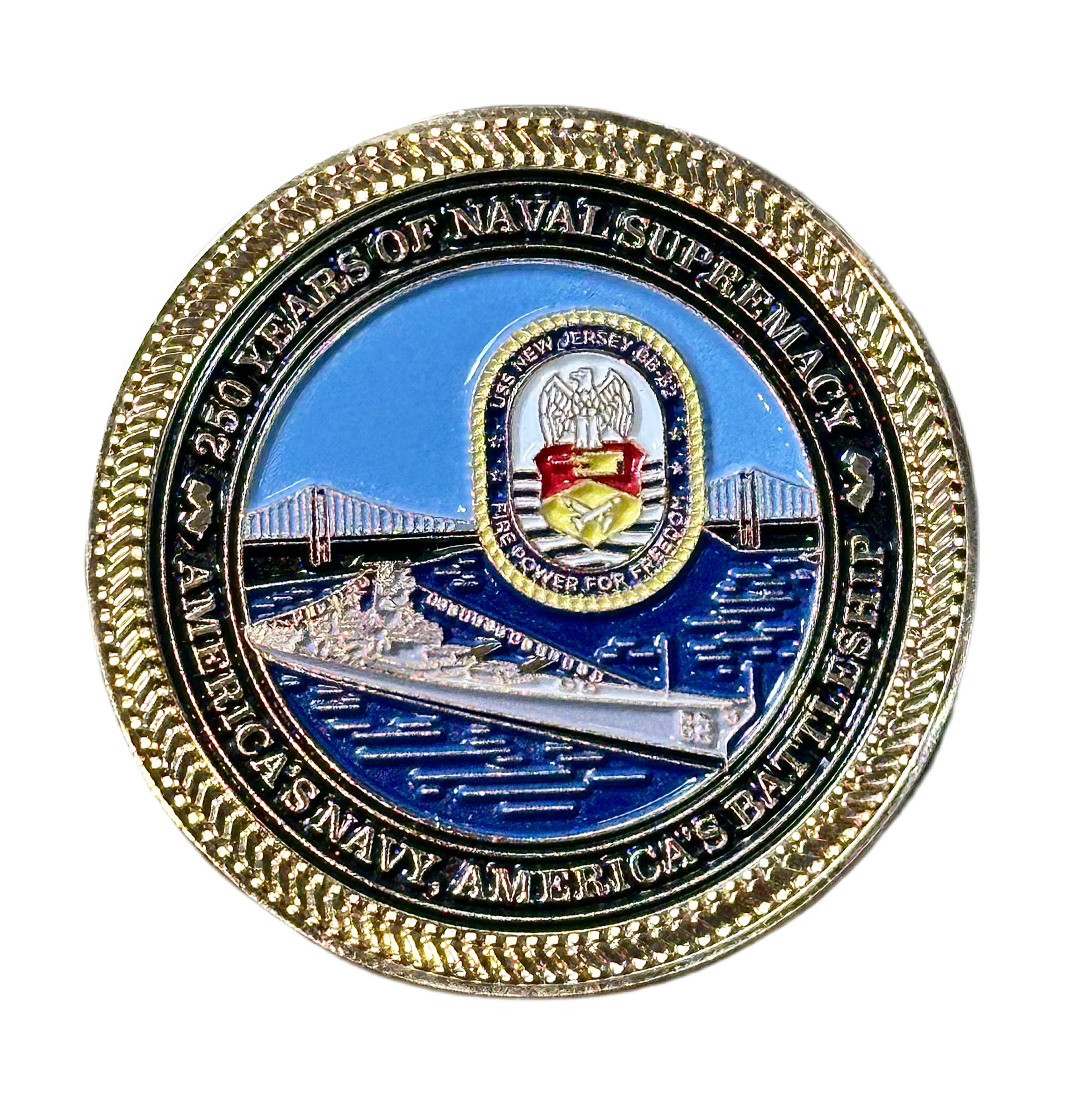 Circular naval commemorative coin with gold border and blue center featuring text and emblem.