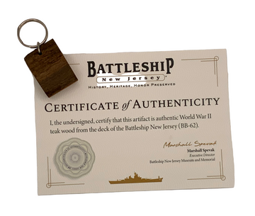 Certificate of Authenticity for World War II teak wood from the Battleship New Jersey with a keychain attached.