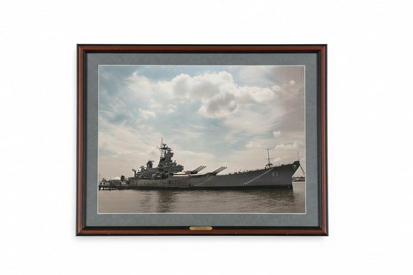 Framed photograph of a large ship on water with a cloudy sky.