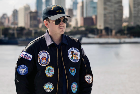 Person wearing a jacket with patches in an urban setting