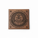 Wooden plaque with engraved text and design on a beige background