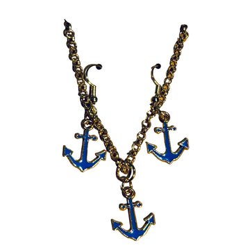 Anchor-shaped earrings on a cardboard backing with a textured surface background