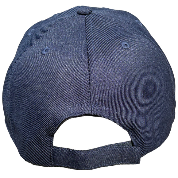 Navy blue baseball cap on a concrete surface