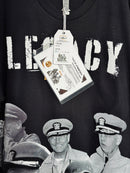 Black t-shirt with 'LEGACY' text and vintage military imagery, featuring a tag with event details. Battleship Graphic T's
