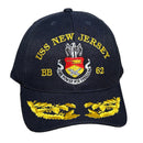 Blue cap with yellow text and embroidery on a concrete surface