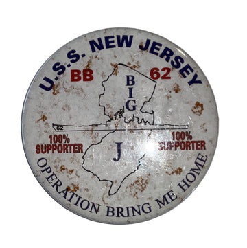 A round white button with the silhouette of the State of New Jersey and the Battleship New Jersey BB 62. It has text and decorative elements around the border.