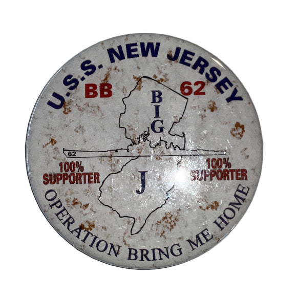A round white button with the silhouette of the State of New Jersey and the Battleship New Jersey BB 62. It has text and decorative elements around the border.