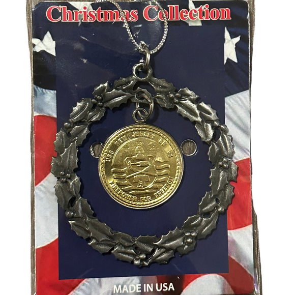 Medal ornament on a Christmas Collection card with American flag design, on a wooden surface.