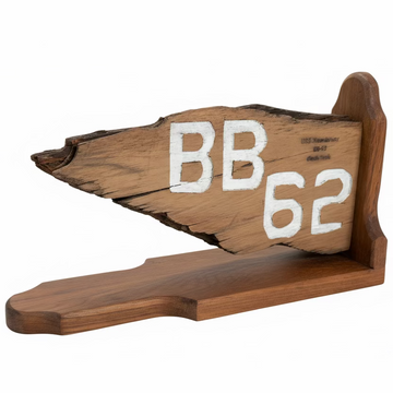 Wooden tool with 'BB 62' engraving on a concrete floor