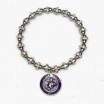 Silver beaded bracelet with a purple pendant on a white background