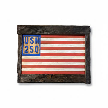 Wooden frame with American flag design and 'USN 250' text on a concrete surface