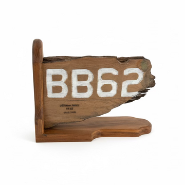 Wooden sign with 'BB62' on a concrete floor