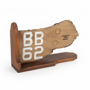 Wooden sign with 'BB 62' on a concrete floor