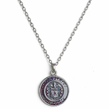 Silver necklace with a round US Air Force pendant on a white background